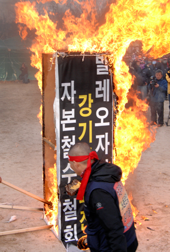 노조 대표자들이 발레오자본을 상징하는 모형을 불태우고 있다. 신동준